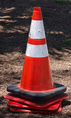 Close view of a stack of red and white traffic cones