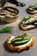 sandwich with sprats, cucumbers and sauce