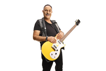 Naklejka premium Mature rocker with an electric guitar smiling at camera