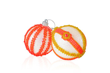 Two Christmas balls decorated with beads on a white background