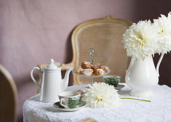 Fototapeta na wymiar tea break in english style, vintage retro still life, homemade buns and a bouquet of white dalias