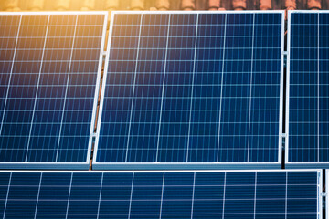 Focus on Solar panels on the red roof. Photovoltaic Solar Energy Zoom Instalation Concept Image.
