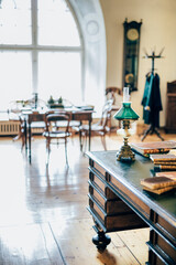 interior of an old house cabinet with books, wooden furniture and lamp