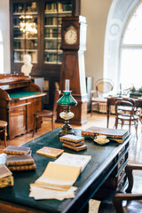 interior of an old house cabinet with books, wooden furniture and lamp