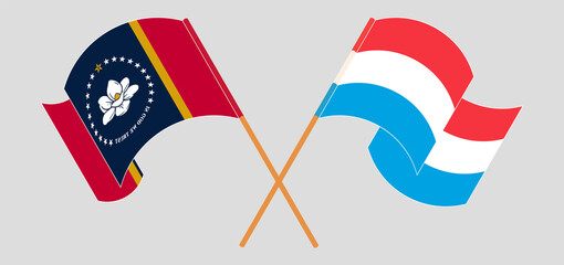 Crossed and waving flags of The State of Mississippi and Luxembourg