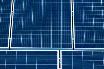 Focus on Solar panels on the red roof. Photovoltaic Solar Energy Zoom Instalation Concept Image.