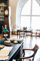 interior of an old house cabinet with books, wooden furniture and lamp