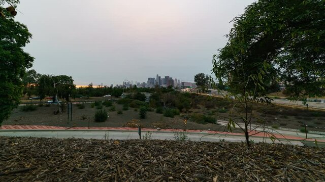 Time lapse tracking shot of downtown LA traffic in smoke from KNP Complex wildfire in California in 2021