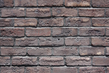 Full frame close-up view of an old brick building wall