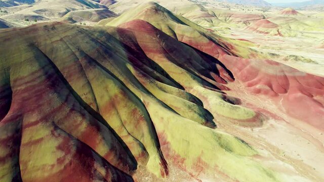 Aerial view of Painted Hills, Oregon, USA. Colorful mountains and bizarre landscapes from bird's eye view