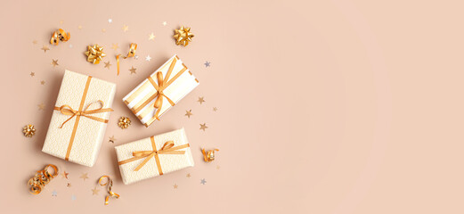 Christmas background with gift boxes wrapped in golden colored paper. Xristmas celebration, preparation for winter holidays. Festive mockup, top view, flat lay - obrazy, fototapety, plakaty