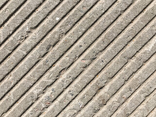 Light gray old city concrete slab with heterogeneous texture in bad weared condition.