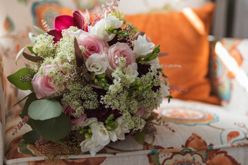 Wedding Bouquet with pink and white roses on a chair. Bridal Flowers. 