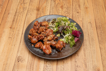 Chopped chicken stewed with Japanese teriyaki sauce garnished with lettuce and sesame seeds and poppies