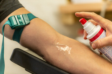 A nurse preparing an intravenous injection for taking a blood sample at a patient´s arm