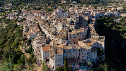 Fototapeta na wymiar Aerial view of the curved city plan of Tourrettes sur Loup in the mountains above Nice on the French Riviera, France - Old stone houses nestled on a belvedere in Provence