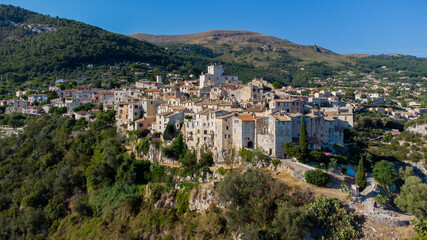 Fototapeta na wymiar Aerial view of the medieval village of Tourrettes sur Loup in the mountains above Nice on the French Riviera, France - Old stone houses nestled on a belvedere in Provence