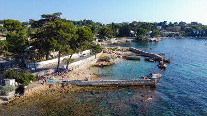 Fototapeta na wymiar Aerial view of a collapsed wall between Ondes Beach and Mallet Beach on the Cap d'Antibes in the French Riviera - Natural pool created by the ruins of a breakwater in the Mediterranean Sea
