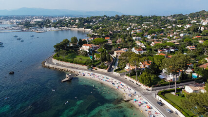 Aerial view of Ondes Beach on the Cap d'Antibes in the French Riviera - Ruins of a flooded round watch tower in the Mediterranean Sea