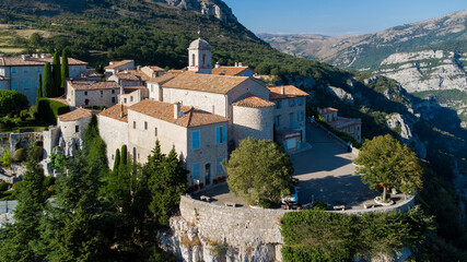 Fototapeta na wymiar Aerial view of the medieval village of Gourdon in Provence, France - Stone church built on the edge of a cliff in the mountains of the Gorges du Loup on the French Riviera