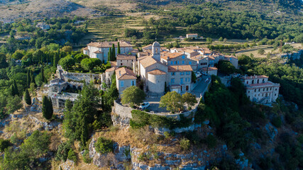 Aerial view of the medieval village of Gourdon in Provence, France - Stone church built on the edge of a cliff in the mountains of the Gorges du Loup on the French Riviera