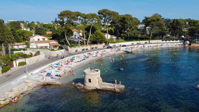 Aerial view of Ondes Beach on the Cap d'Antibes in the French Riviera - Ruins of a flooded round watch tower in the Mediterranean Sea
