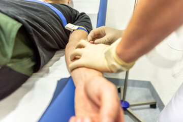 A nurse placing an infusion to a patient
