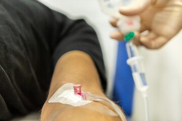 A nurse placing an infusion to a patient