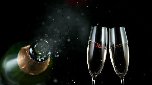 Super slow motion of Champagne explosion with flying cork closure, opening champagne bottle closeup. Filmed on high speed cinematic camera at 1000 frames per second.