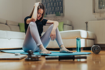 Woman being tired after her training at home