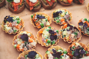 Catering table, beautifully decorated banquet with variety of with different food snacks and appetizers on corporate birthday party event or wedding celebration, seafood, canape, delicatessen setting