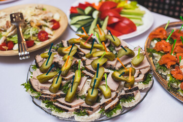Catering table, beautifully decorated banquet with variety of with different food snacks and appetizers on corporate birthday party event or wedding celebration, seafood, canape, delicatessen setting