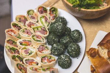 Catering table, beautifully decorated banquet with variety of with different food snacks and appetizers on corporate birthday party event or wedding celebration, seafood, canape, delicatessen setting