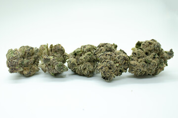 Cluster of Golden Goat and Blue Dream cannabis flower on a white background.