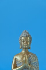 Buddha statue on a blue background.Meditation and relaxation .Buddhism religion background.Buddhism religion symbol.Meditation and relaxation ritual.
