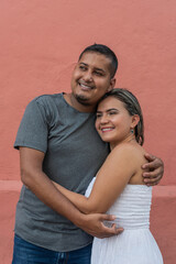 Hispanic couple having fun outside and smiling.