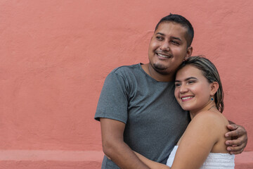 Happy young couple having fun outside and smiling.