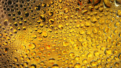 blurry drops of water on glass. background and texture