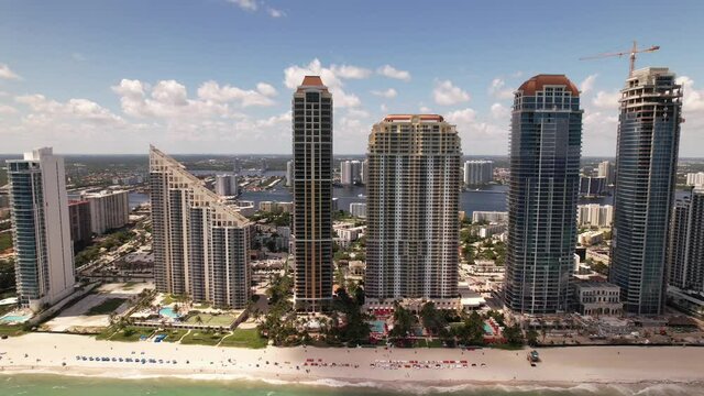 Aerial side view highrise condos in Sunny Isles Miami Beach FL. 5k drone video footage