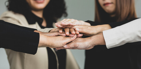 Close up shot of holding hands of unidentified unrecognizable successful female businesswoman group...