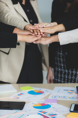 Close up shot of holding hands of unidentified unrecognizable successful female businesswoman group...