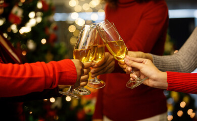 Women on sweater clink glass of ิิbeverage together to start holiday event of jolly drink at gala party for celebrating group success, cheerful relationship
