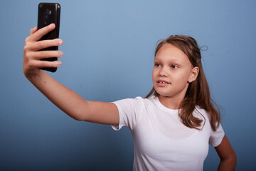 Fototapeta premium a beautiful girl of 11 years old takes a selfie