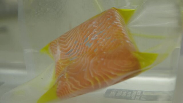Melting salmon fillet oil in sealed zipper bag 