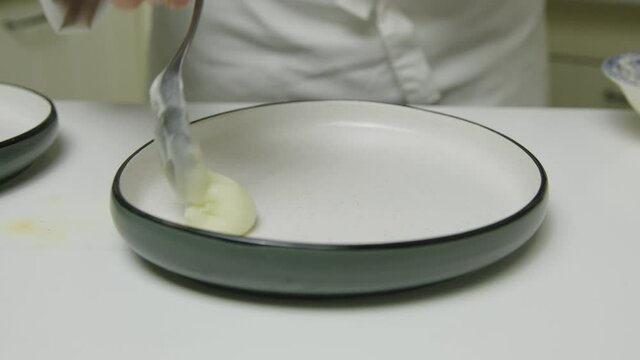 Thickened radish puree on salmon ceramic platter serving