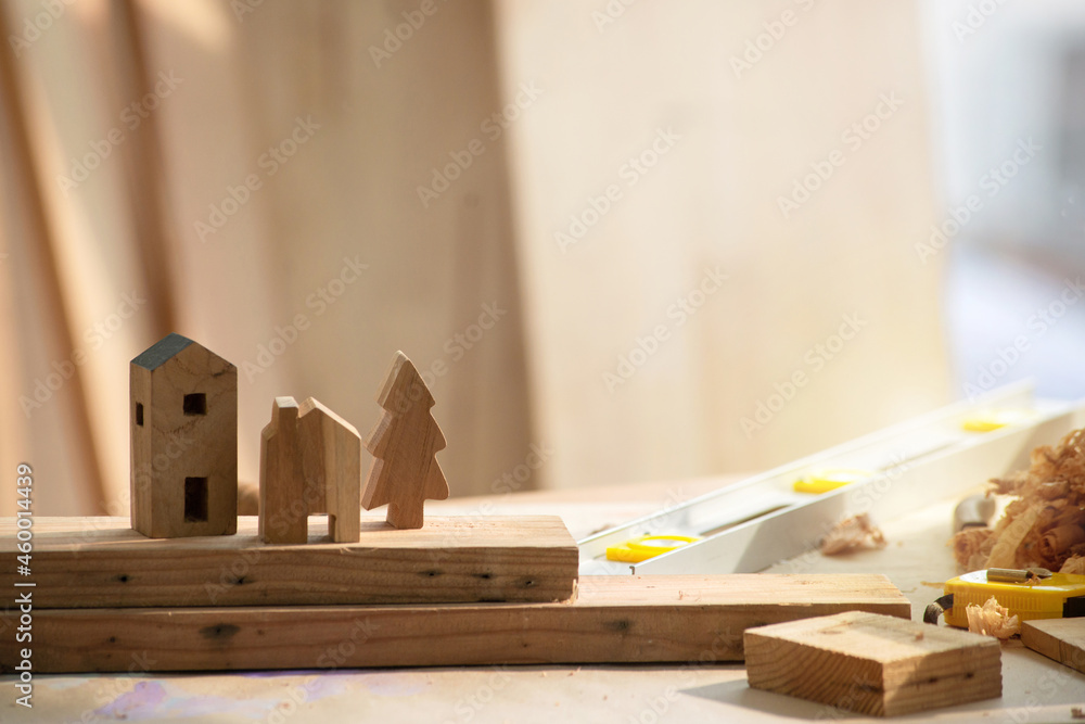 Wall mural wooden little houses and christmas tree in workshop studio, diy wood work, wooden plank in backgroun