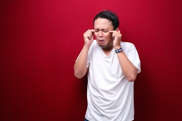 Crying face of Young Asian man with hand gesture. Advertising model concept.