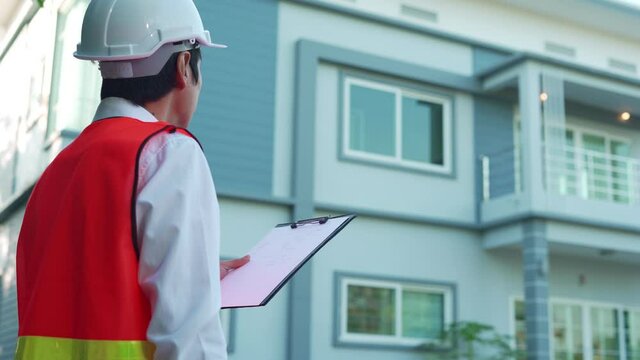 Engineer and construction concept. Inspector engineer is inspecting the house with reference to the construction standards. Engineers are doing final checks before delivering to clients.