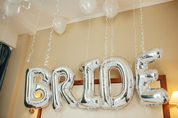 Perfect decor for the bride's morning. Bed is decorated with white balloons.