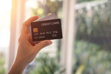 Close up of woman's hand holding a credit card.	
